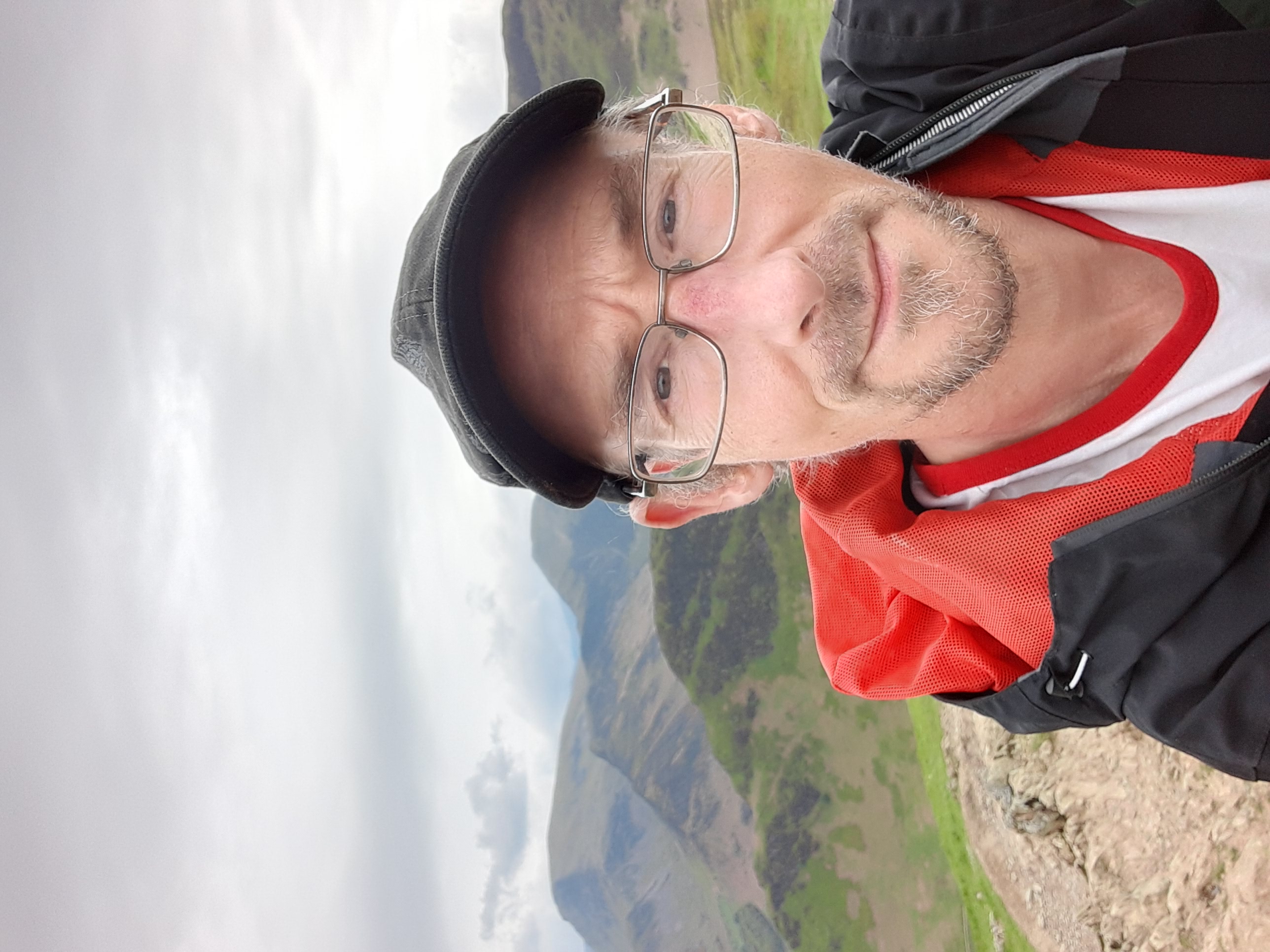 Phil Clarke, professional garden designer, shown with a mountain view in the background